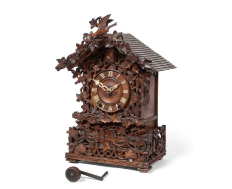 A Black Forrest Striking Cuckoo Table Clock, circa 1880, elaborately carved chalet form case, side doors, cuckoo opening wind