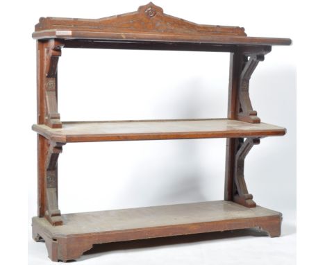 An antique 19th Century Victorian reformed gothic oak three tier dessert buffet sideboard stand having a carved gallery back,