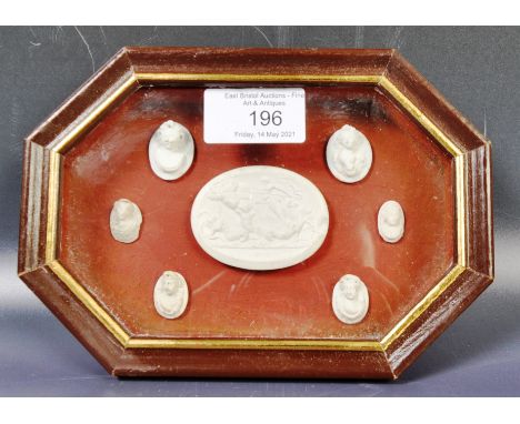 An antique 19th Century Italian grand tour plaster cameo collection containing a central oval cartouche panel with scenes of 