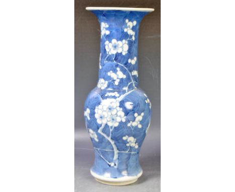 An antique 19th Century Chinese Oriental Kangxi mark blue and white vase of baluster shape having a flared circular rim, tape