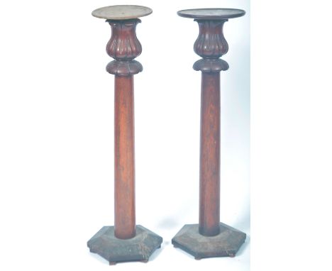 A pair of antique 19th Century mahogany torchere bust planter jardiniere plant stands having a turned wooden top with carved 