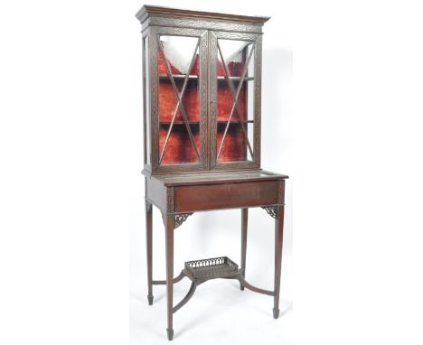 An antique late 19th Century mahogany display cabinet bijouterie vitrine in the manner of Chippendale having a twin door, two