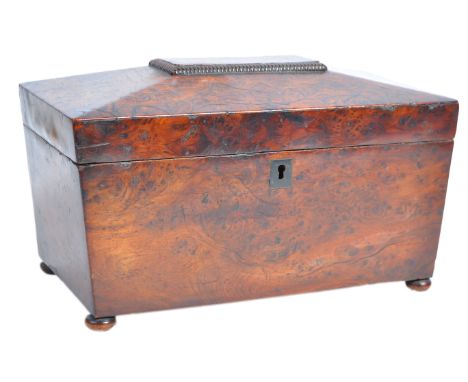 An early 19th Century Georgian Regency English antique burr walnut tea caddy of sarcophagus form. The outer case having gadro
