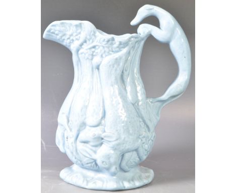 An antique 19th Century Victorian Staffordshire pottery teal blue glazed Game / Hunting jug / pitcher. The jug having a greyh