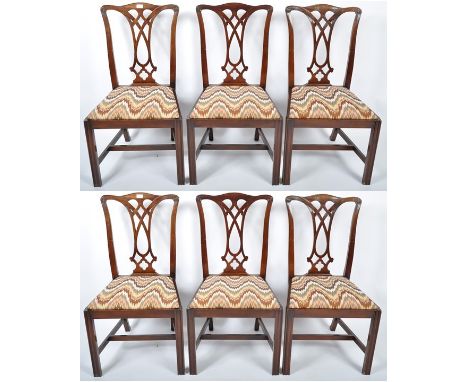 A set of six 20th Century Chippendale Revival mahogany dining chairs having a hand carved scrolled and decorative pierced vas