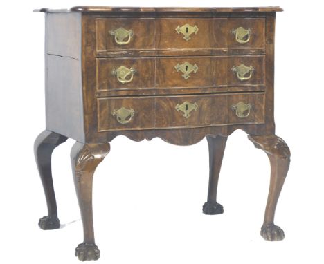An antique 19th Century Dutch walnut commode chest of drawers of good small proportions. The bank of three drawers having a s