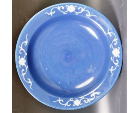 An antique 19th Century Chinese Oriental powder blue finished bowl having a raised lipped rim with white scroll and floral de