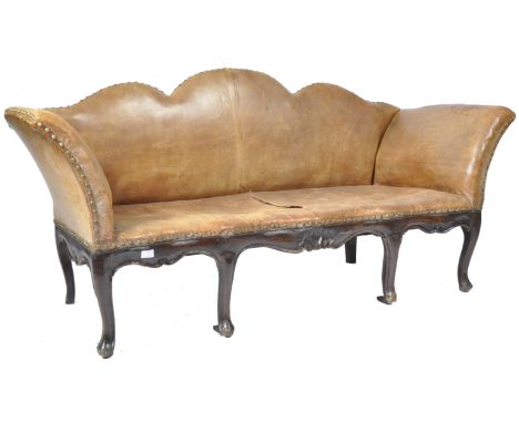 An antique 19th Century Georgian leather ' Camelback ' sofa settee having a shaped serpentine back with studded nailhead deta