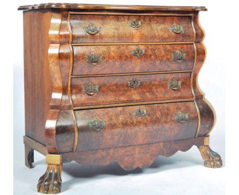 An antique 18th / 19th Century walnut commode chest of drawers of serpentine bombe form. The graduating bank of three drawers