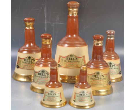 A collection of 8x assorted Bells whisky ceramic decanters of various sizes comprising 75.7cl example down to 18.75cl and oth