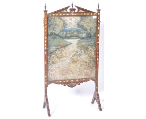 An antique 19th Century English Victorian silk worked firescreen having a mahogany frame with arched pediment top with brass 