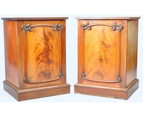 A pair of antique 19th Century mahogany pedestal cabinets. The stands of upright square form having carved detailing to the d