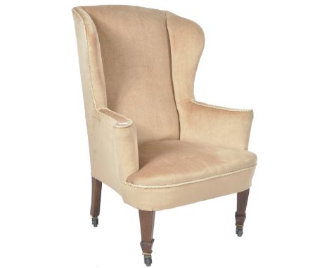 An antique 19th Century Victorian Georgian manner wing chair wing back fireside armchair having a tall shaped back with cushi