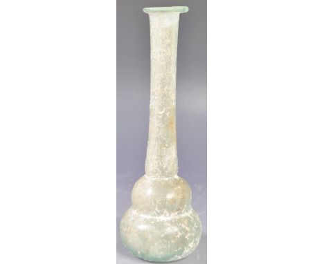 An antique 1st - 3rd Century AD very early Roman unguentarium vase bottle of elongated form with circular rim, cylindrical st