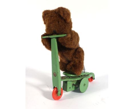 A Gebruder Fewo-type clockwork figure modelled as a bear riding a scooter, h. 16.5 cm   CONDITION REPORT:  Typical losses and