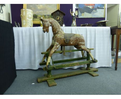 A late 19th/early 20th century small painted pine rocking horse on a twin pillar stand, h. 81 cm   CONDITION REPORT:  In need