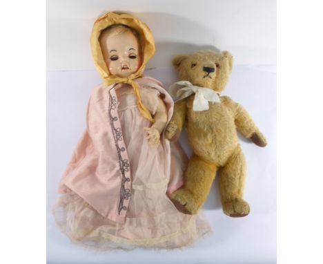 A Chad Valley fully jointed bear, l. 40 cm, together with a hard plastic 'walking' doll having flirty eyes (2)   CONDITION RE
