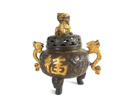 A Chinese brown patinated and gilt highlighted bronzed koro of traditional form, having a foo dog finial and a pair of dragon