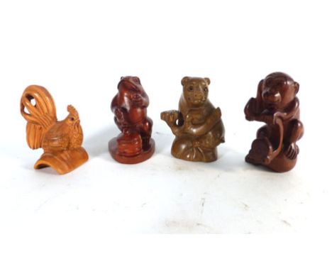 A modern carved wood netsuke in the form of a seated frog, h. 5 cm and three further netsukes, each signed (4)   CONDITION RE