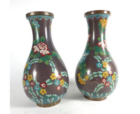 A pair of cloisonne vases of baluster form decorated with flowering shrubs on a mauve ground, h. 23.5 cm   CONDITION REPORT: 