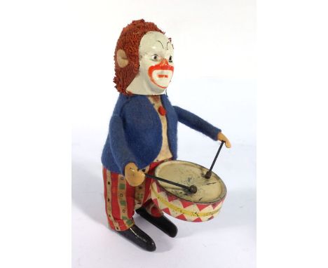 A Schuco clockwork figure modelled as a clown playing a drum, h. 11 cm   CONDITION REPORT:  Typical wear and damage. Working 