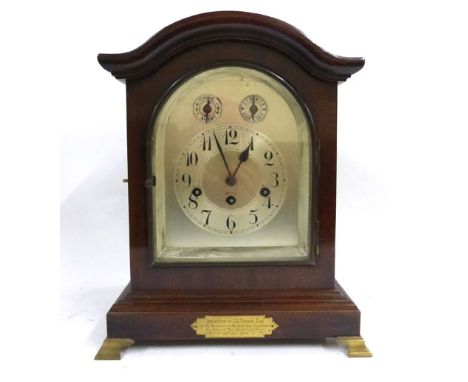 An early 20th century mantle clock, the Junghans movement chiming and striking on a gong, the silvered dial within a brass mo