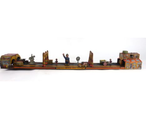 A Marx tinplate layout modelled as 'Main Street', l. 61 cm   CONDITION REPORT:  Typical losses and wear. Working order unknow