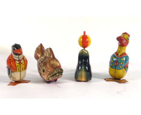 A Japanese clockwork figure modelled as a fish consuming a smaller fish, l. 16.5 cm, an 'Animals Playing See-Saw' figure and 