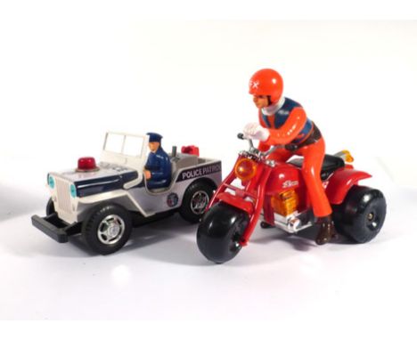 A Japanese battery operated 'Kissing Couple' model, a Cragstan 'Shaky Old-Timer Car' and two further battery operated models,
