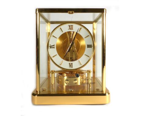 A Jaeger-LeCoultre 'Atmos' clock, the cream dial with Roman numerals and a visable escapement within a gilt metal five glass 