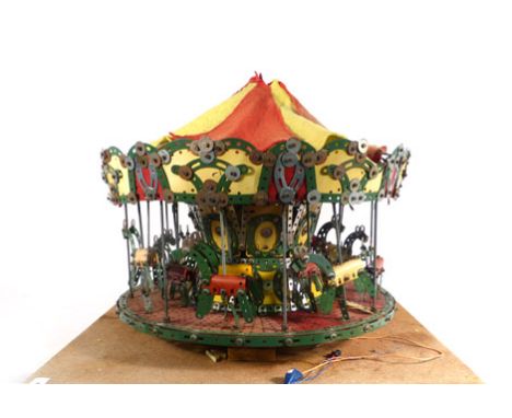 A 1950's Meccano shop display model in the form of a fairground merry go round,h. 40 cm,d. 52 cm   CONDITION REPORT:  Complet