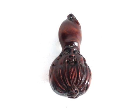 A modern carved wood netsuke of gourd shaped form decorated with a males head, signed, h. 7 cm   CONDITION REPORT:  Minor wea