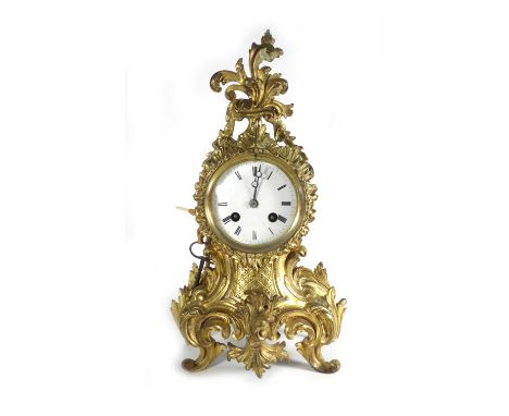 A 19th century French mantle clock, the enamelled face with Roman numerals, the movement striking on a gong, within a gilt me