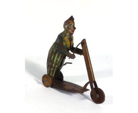 A Lehman-type clockwork figure modelled as a clown riding a scooter, h. 12 cm   CONDITION REPORT:  Poor condition. Working or