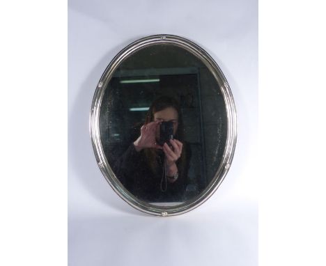 An Austrian metalware mounted mirror of oval form, l. 38 cm, together with a silver engine turned hand mirror (2)   CONDITION
