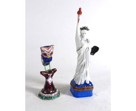 A Limoges novelty pill container in the form of the Statue of Liberty, h. 13 cm, together with an enamelled figure modelled a