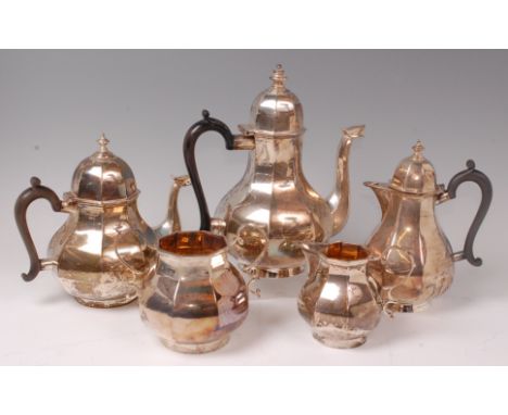 An Edwardian silver four piece tea and coffee service together with a near-matching hot water pot,  comprising; coffee pot, t