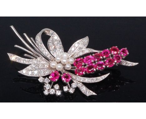 A contemporary platinum, ruby, diamond and seed pearl set brooch, as stylised leaves and flowers, arranged as two rows of gra