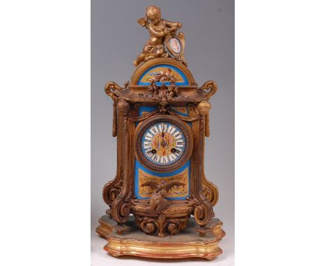 A late 19th century French gilt metal mantel clock in the Louis XVI style, the whole with inset Sevres type porcelain panels 