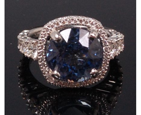 A Michael B platinum, tanzanite and diamond ring, the four claw set antique cushion cut tanzanite weighing approx 4.5ct, in a