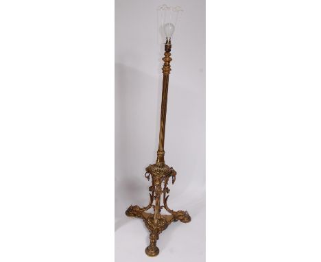 A late Victorian brass telescopic lamp standard, having fluted column to triform base with lion masks and paw feet, h.121cm (