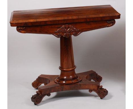 An early Victorian rosewood card table, the D-shaped foldover top revealing a baize lined playing surface, on turned column, 