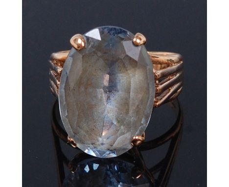 A modern 9ct gold and aquamarine dress ring, the four claw set oval cut aquamarine weighing approx 8ct, size M (stone require