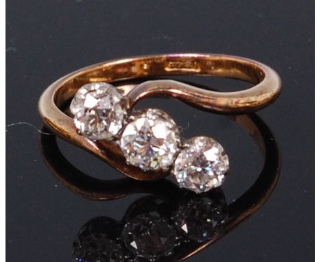 An Edwardian 18ct gold and diamond crossover ring, the centre old brilliant weighing 0.34ct, colour assessed as J/K and clari