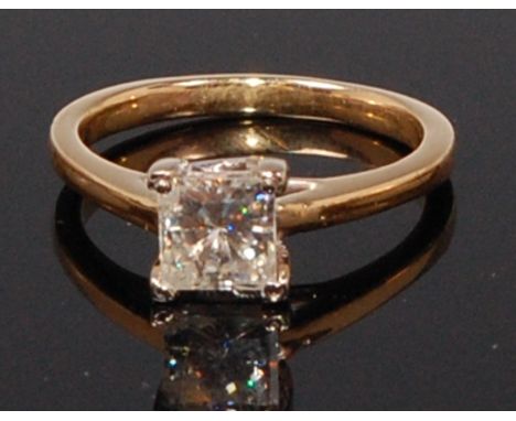 An 18ct gold diamond solitaire ring, the four claw set princess cut diamond weighing approx 0.9ct, size M/N