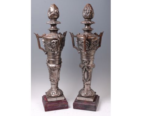 A large pair of circa 1900 cast iron and steel plated architectural finials, each of three handled elongated urn form, with f