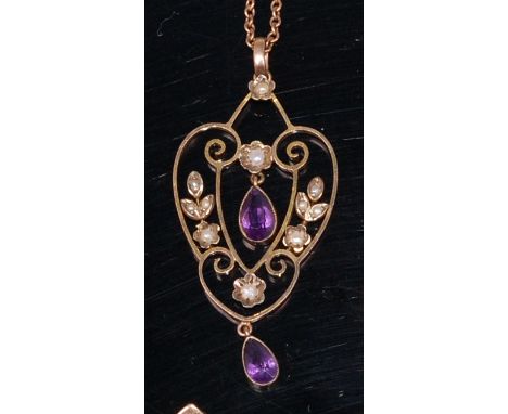 An Edwardian 9ct gold, amethyst and seed pearl set openwork pendant, 4cm (excluding bale), on 9ct finelink neck chain