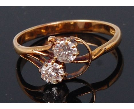 An 18ct gold and diamond crossover ring, the two round brilliant cut diamonds each weighing 0.24ct, colour assessed as K/L an