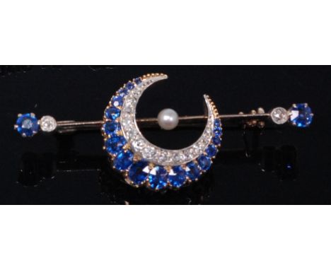A yellow metal, sapphire and diamond set crescent knife-edge bar brooch, having centre seed pearl, the crescent with graduate