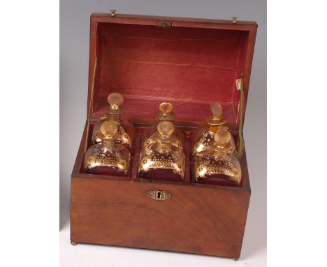 A Victorian walnut fitted decanter box, the cover opening to reveal six square spirit decanters and stoppers, each with gilt 
